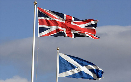 APAM5C Union Flag and Scottish flags flying in strong wind